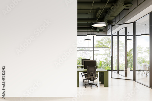 Photos Contemporary office interior with blank wall mockup and modern workspace featuring green desks, ergonomic chairs, and large glass windows with greenery