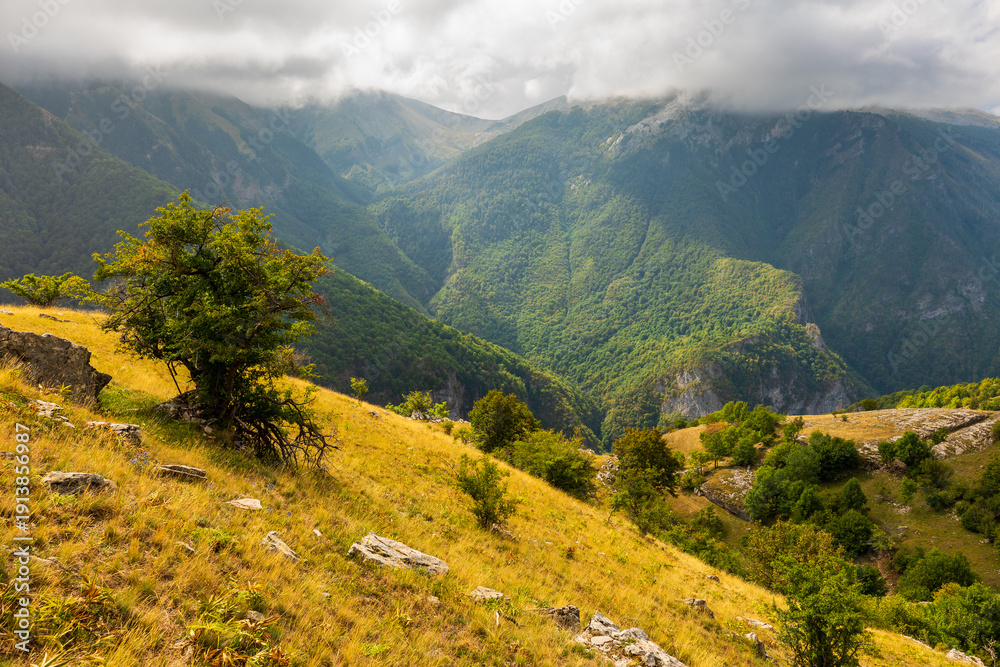 Naklejka premium Mountain valley landscape with cloudy sky in Konjic, Bosnia Herzegovina.
