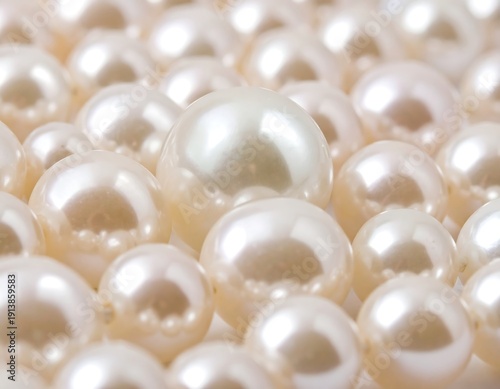 Close-up of multiple lustrous, spherical gems arranged in rows, with one centered pearl prominently displayed