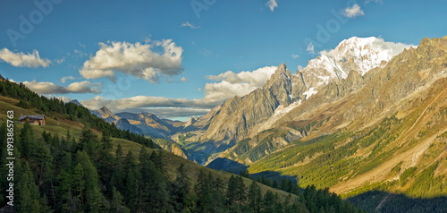 Val d'Aosta, Italy - August 15, 2025: Wide view of the Mont Blanc massif with jagged granite peaks and hanging glaciers above Val Veny.