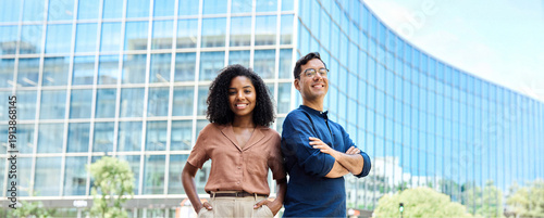 Quadro su tela Young happy smiling professional office team of two diverse confident female and male partners business people man and woman standing outdoors on city street looking at camera, corporate portrait