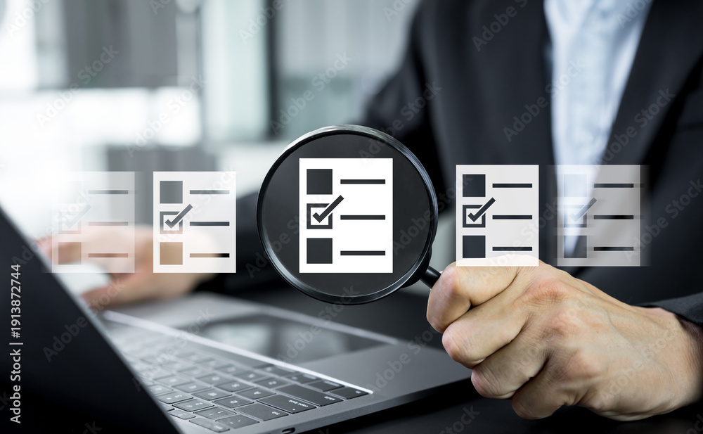 Fototapeta premium Businessman searches online documents and archived files, reviewing digital reports and information to represent organized data management and efficient business documentation processes.
