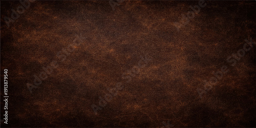 A rough dark brown leather texture with an aged grunge pattern creates a vintage weathered surface design ideal for a retro wallpaper backdrop or ancient parchment material