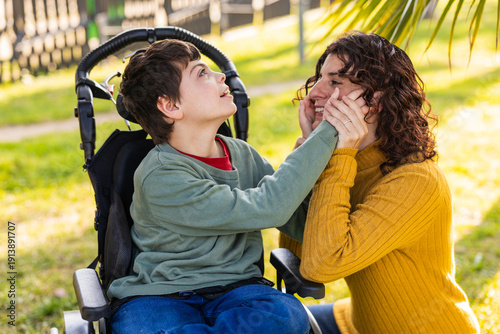 child playing with mother outdoors in wheelchair, cerebral palsy and intellectual disability awareness
