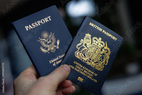 Photos A close-up lifestyle image featuring a British and American passport placed side