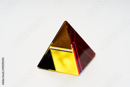 Luxury Golden and Red Glass Pyramid 3D Render on White Background