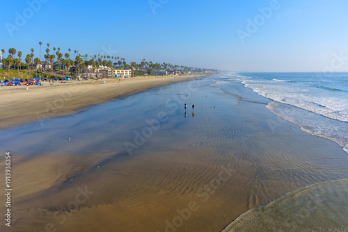 Wallpaper Mural Vast Oceanside Beach Landscape with People and Coastal Buildings Torontodigital.ca