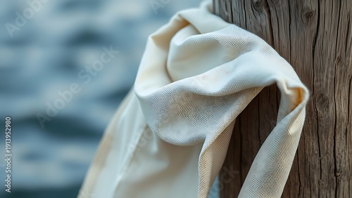 sailcloth. Weathered sailcloth with stitching, rolled against a wooden dock post. mobility guides, transit brochures, designed for mobility and urban transit guides, supports logistics messaging.