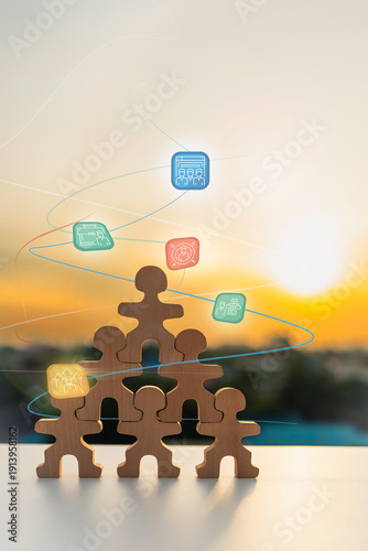 Wooden people figures pyramid with digital human resources icons on sunset background for organization structure, leadership teamwork, corporate management and business networking concept.