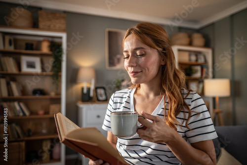 Фотография Woman enjoying a cozy moment reading a book at home