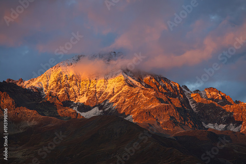 A beautiful sunset of golden Caucasus mountain scenery in the rural countryside of Ushguli Village, Georgia