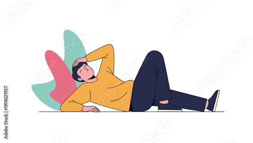 Young man lying down on floor with hand on forehead looking exhausted or depressed against abstract background.