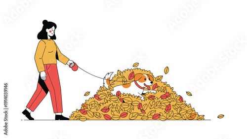 Young woman walking her pet dog on a leash while the playful animal jumps into a large pile of crunchy fallen autumn leaves.