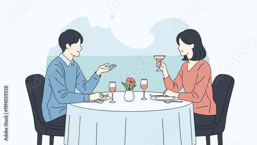 Romantic man and woman enjoying a candlelit dinner with glasses of wine at a table set with a view of the calm blue ocean.