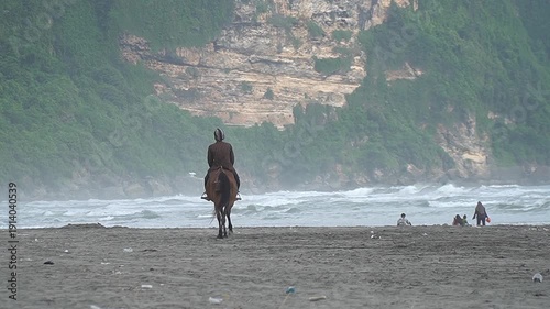 Horse Riding on the Beach Below a Cliff Hill