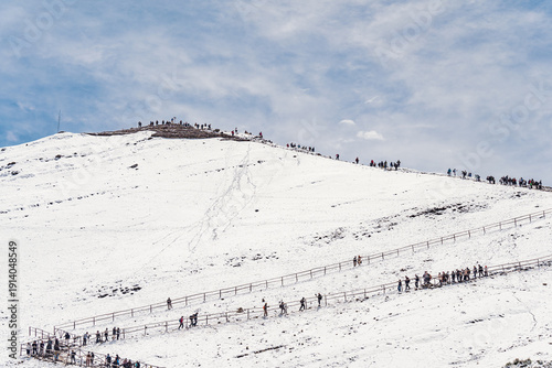 Wallpaper Mural  Many tourists hikers walking through the snow covered Andean mountain on the winding trail path to Vinicunca mountain also called Rainbow mountain Torontodigital.ca