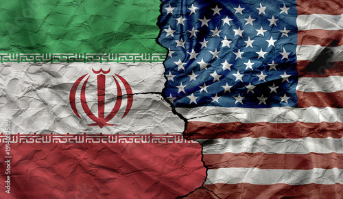 US and Iran flags on a cracked background. Political and military conflict between Iran and the US.