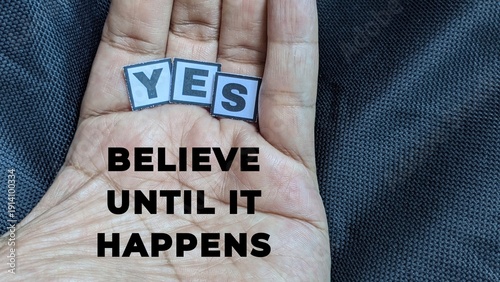 Vászonkép Believe Until It Happens|A close-up of a hand holding tiles that spell YES alongside an encouraging message about persistent belief