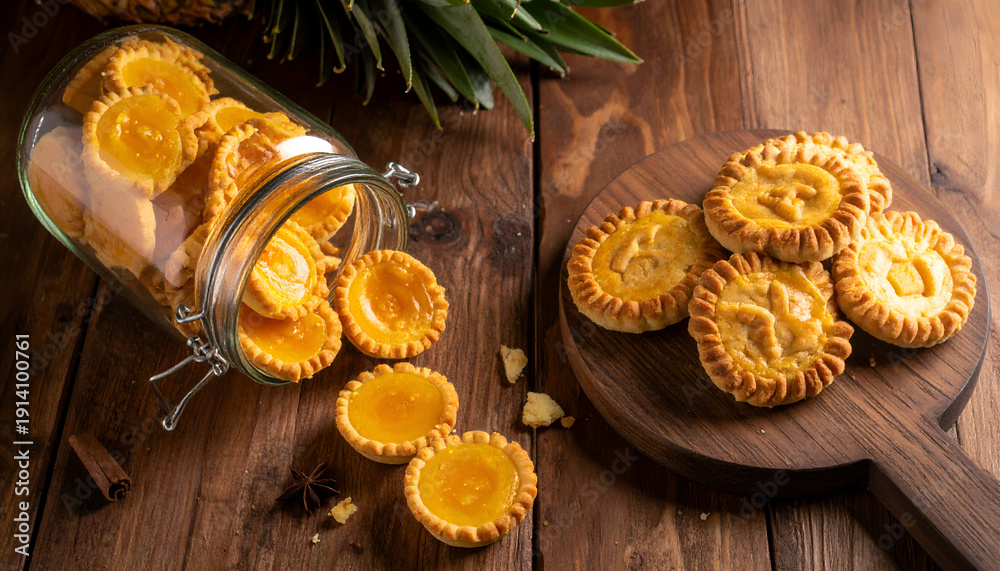 Fototapeta premium Pineapple cookies on a wooden table with a jar.