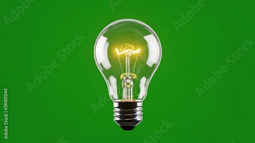 Glowing Incandescent Light Bulb on Green Screen Background.