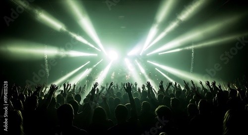 Concert Crowd Silhouette with Green Stage Lighting and Raised Hands