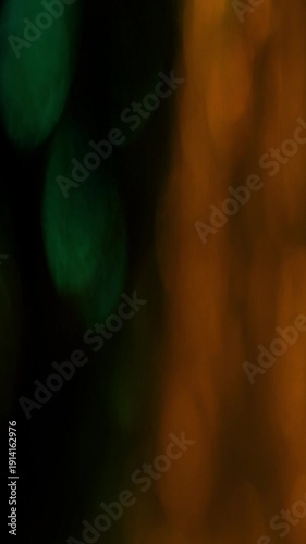 Dynamic Vertical Light Leak Bokeh Transition with vibrant green and orange hues, perfect for creative projects.