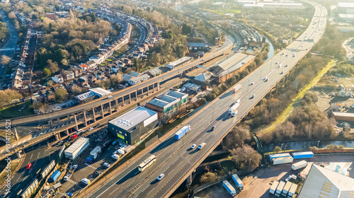 Aerial view of fast moving traffic on the M6 motorway in Birmingham, UK, with early morning sunlight