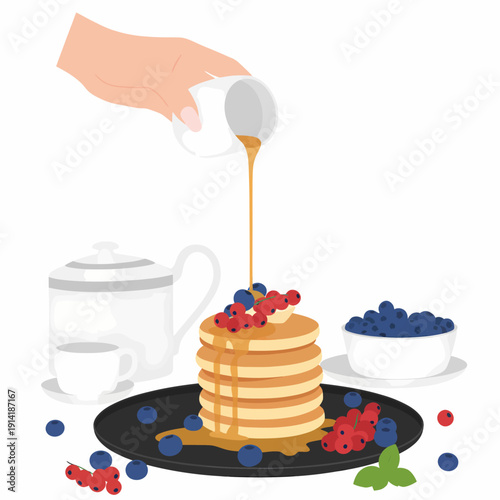 A hand pours syrup onto a stack of pancakes with berries on a black plate