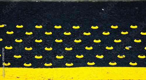 yellow studs on black background