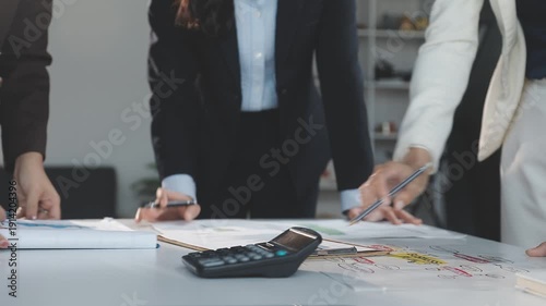 Two Businessman Calculating Bills Using Calculator At Workplace. Business team meeting and discussing project plan. Businessmen discussing together in meeting room