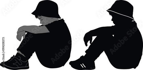 Two boys sitting in a dejected or pensive posture