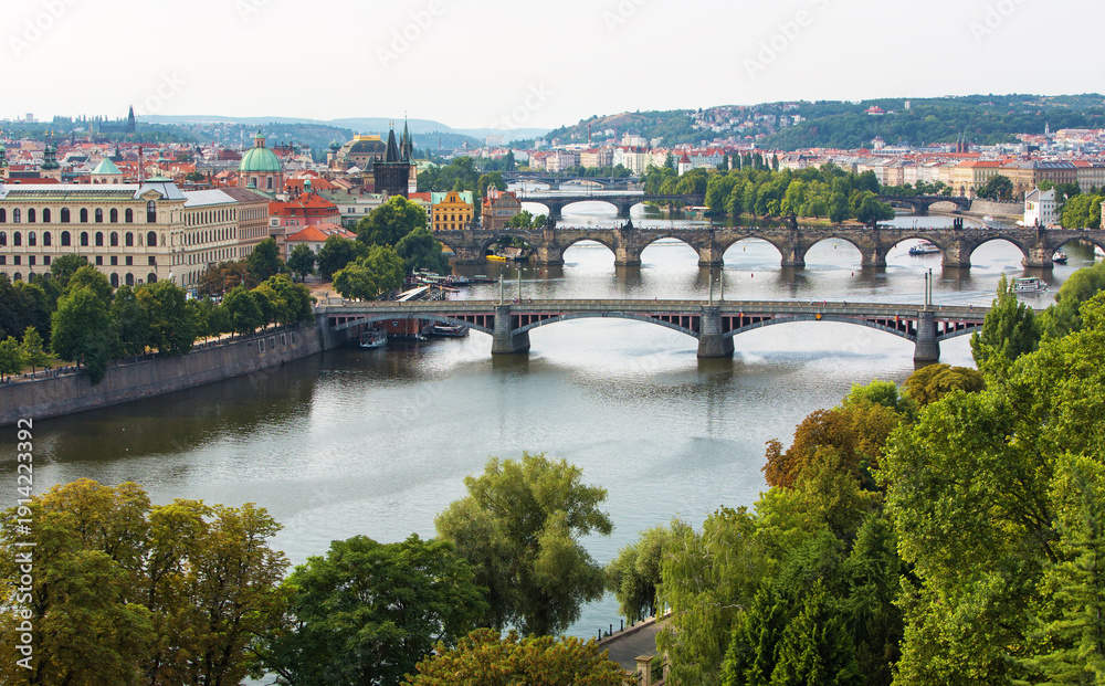 Fototapeta premium Charles Bridge (Karlův most) in Prague, Czech Republic, spanning the Vltava River with historic towers and Gothic architecture. Panoramic view of the medieval bridge and city skyline, iconic European 