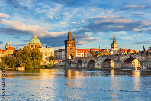 Charles Bridge (Karlův most) in Prague, Czech Republic, spanning the Vltava River with historic towers and Gothic architecture. Panoramic view of the medieval bridge and city skyline, iconic European 