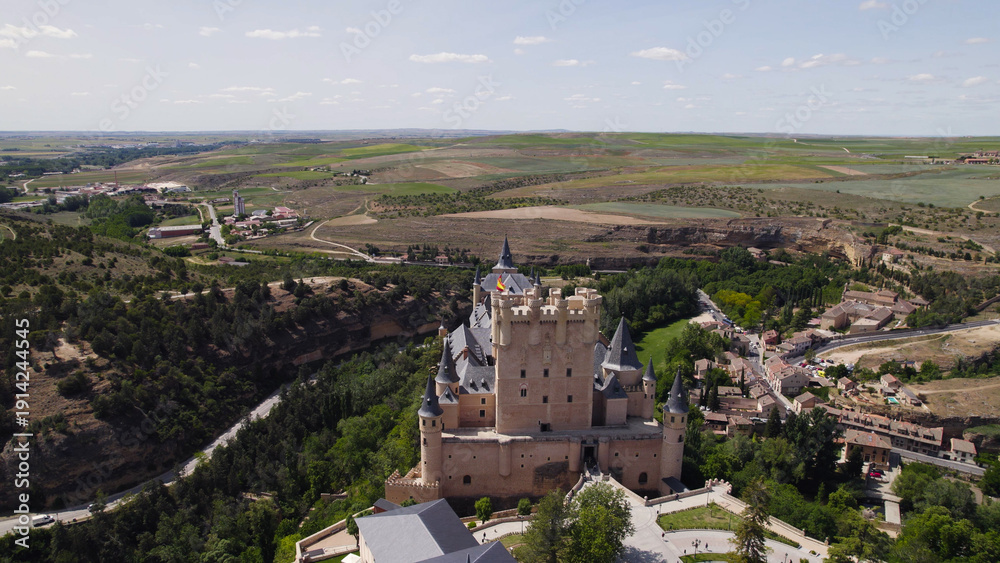 Fototapeta premium Drone Aerial of Alcázar de Segovia Contrasting with the Landscape, Spain