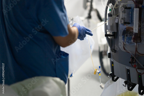 Photos Healthcare professional preparing dialysis machine for renal treatment