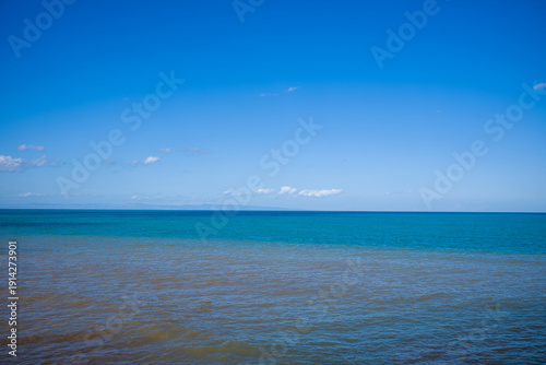 Obraz na płótnie A tranquil view of the Adriatic Sea near Trani, Italy, features calm turquoise water meeting a vivid blue sky with a few scattered clouds
