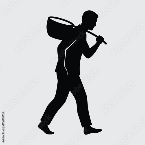 Silhouette of a Working Man Carrying a Heavy Basket on His Shoulder.