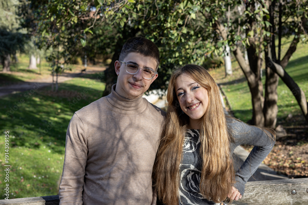 Fototapeta premium Young couple smiling together in park at autumn
