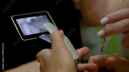 Medical practitioner performs advanced airway management using a video laryngoscope on a male training mannequin. Close-up clinical simulation of emergency intubation procedure.