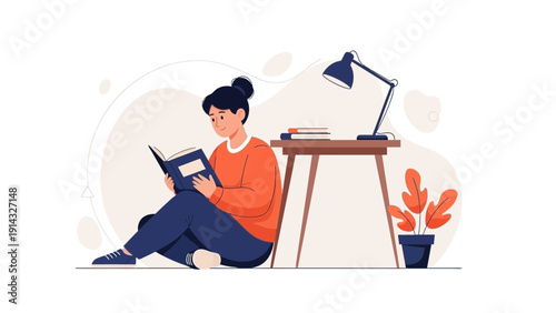 Young Woman Reading Book Sitting on Floor Near Desk with Lamp and Plant