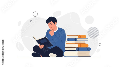 Young man sitting, reading a book, surrounded by stack of books, learning, studying