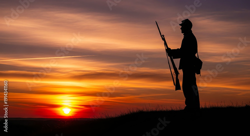 Silhouette of a Civil War soldier with rifle at sunset on a hill