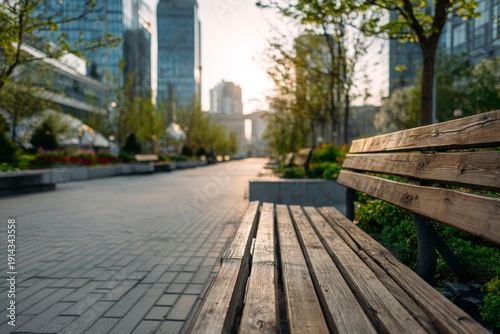 Wooden park bench in modern city boulevard at sunrise