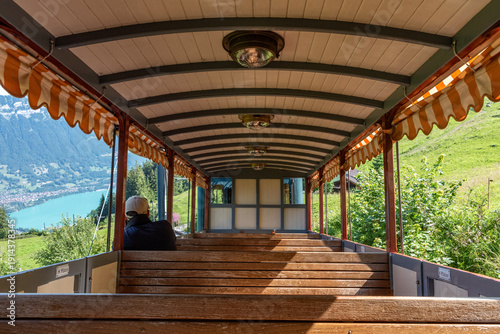Wallpaper Mural Schynige Platte, Switzerland - August 13, 2025 - A tourist sitting in an empty wagon of the Schynige Platte railway enjoying the view Torontodigital.ca