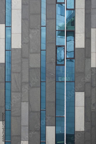 Contemporary university facade with blue glass windows in Leipzig, Germany. 