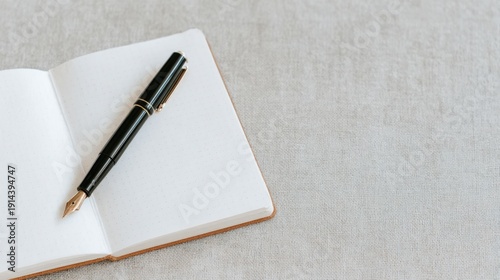 A pen is sitting on top of a notebook