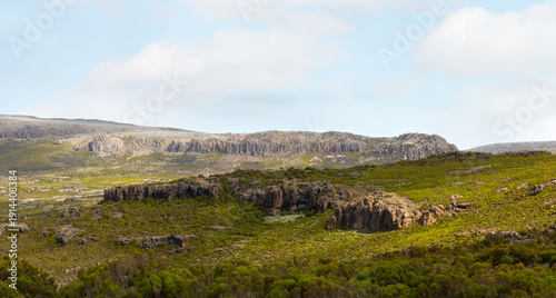 Photography Rugged volcanic rock formations and green shrubland in Ethiopian Highlands