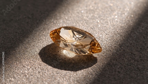 Sunlight Shines on a Yellow Gemstone Placed on a Textured Surface in a Simple...