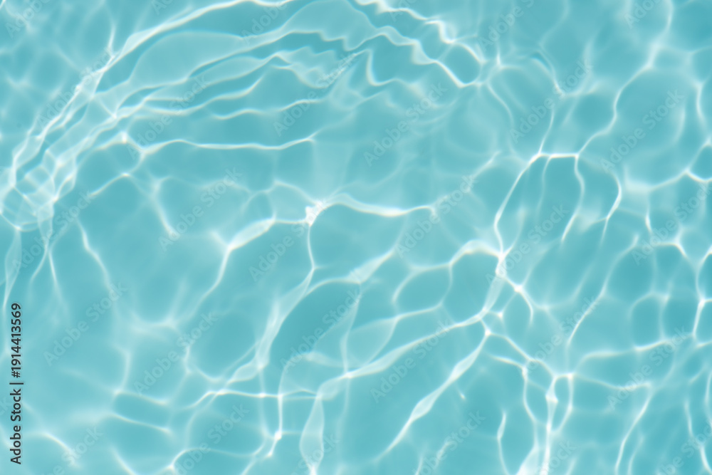 Obraz premium Blue water with ripples on the surface. Defocus blurred transparent blue colored clear calm water surface texture with splashes and bubbles. Water waves with shining pattern texture background.