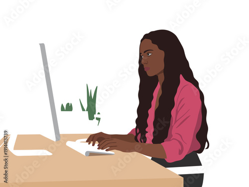 Professional woman with long dark hair typing on a desktop computer at her desk.